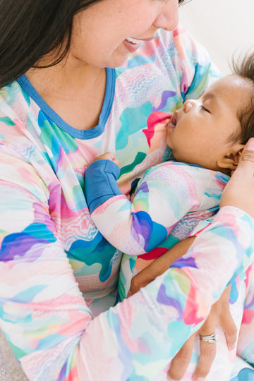 Close up o from and baby wearing pastel colored mountain peaks matching outfits