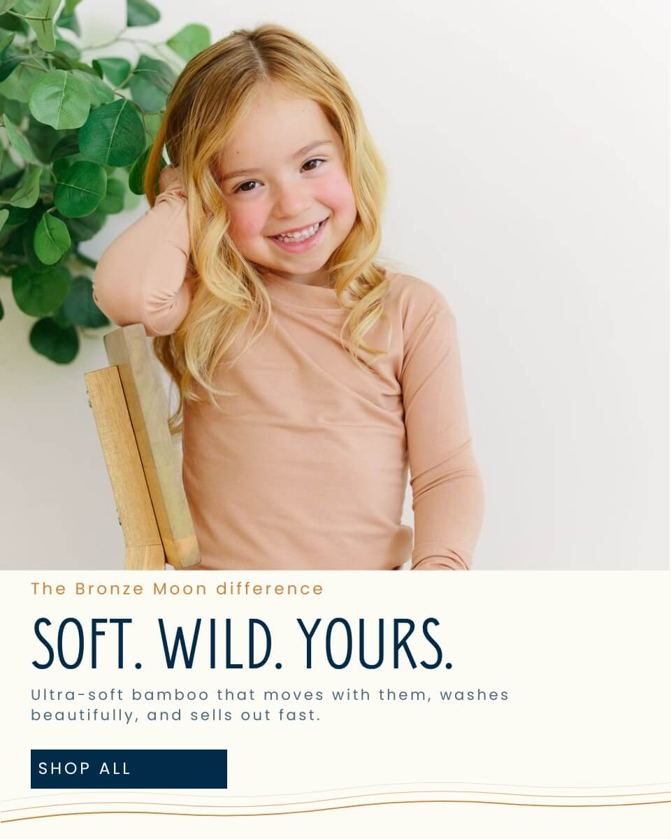Young girl with blonde hair sitting on a wooden stool with a white background and text about Bronze Moon products.1621243260e1af0c20-0