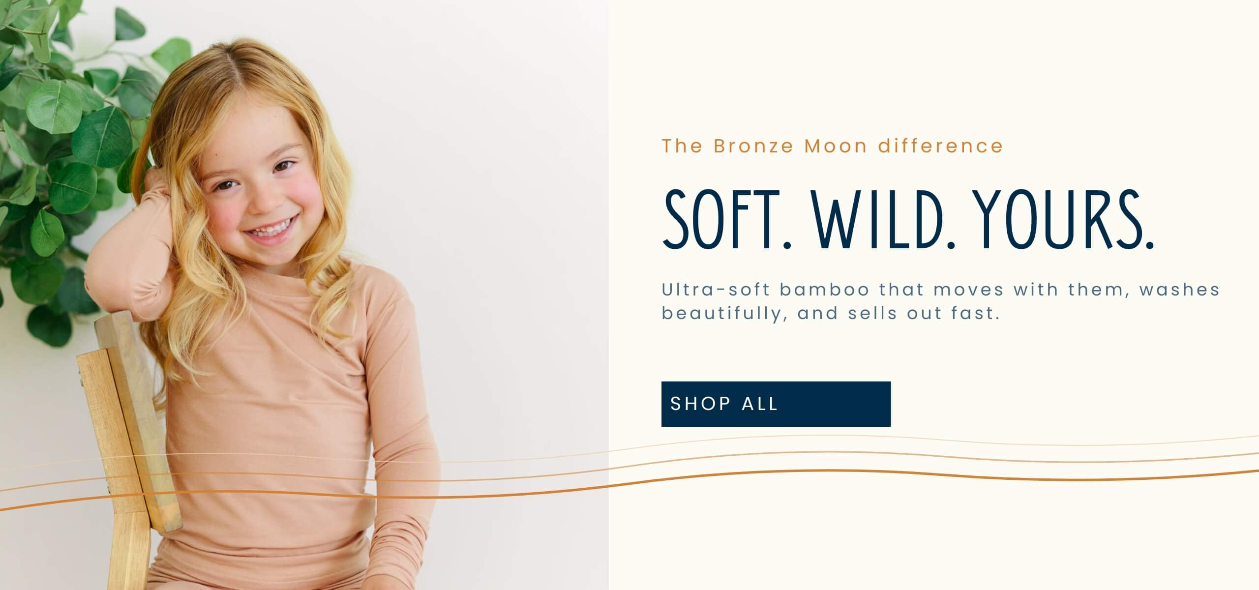 Young girl with blonde hair sitting on a wooden stool with a white background and text about Bronze Moon products.1621243260e1af0c20-0