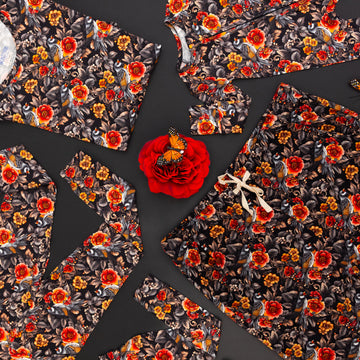 Floral-patterned fabric pieces on a dark background with red and orange flowers.