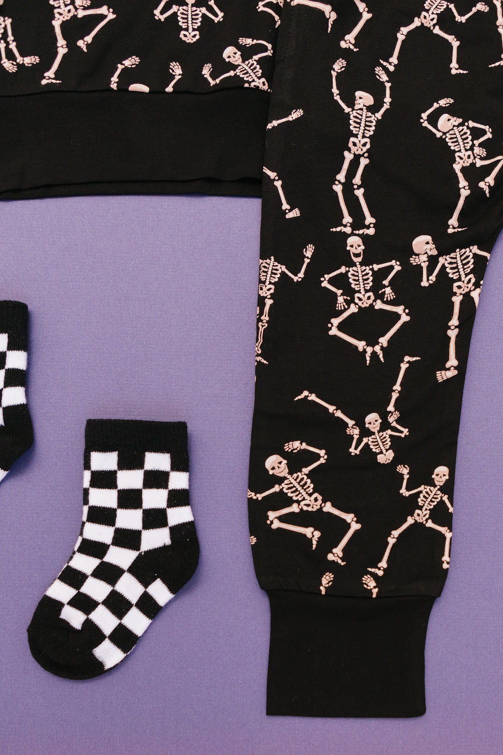 Close up of Kids bamboo jogger set in black Dancing Skelly’s skeleton print.