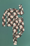 Reverie floral two-piece bamboo set with cream and blush flowers on a dark green background