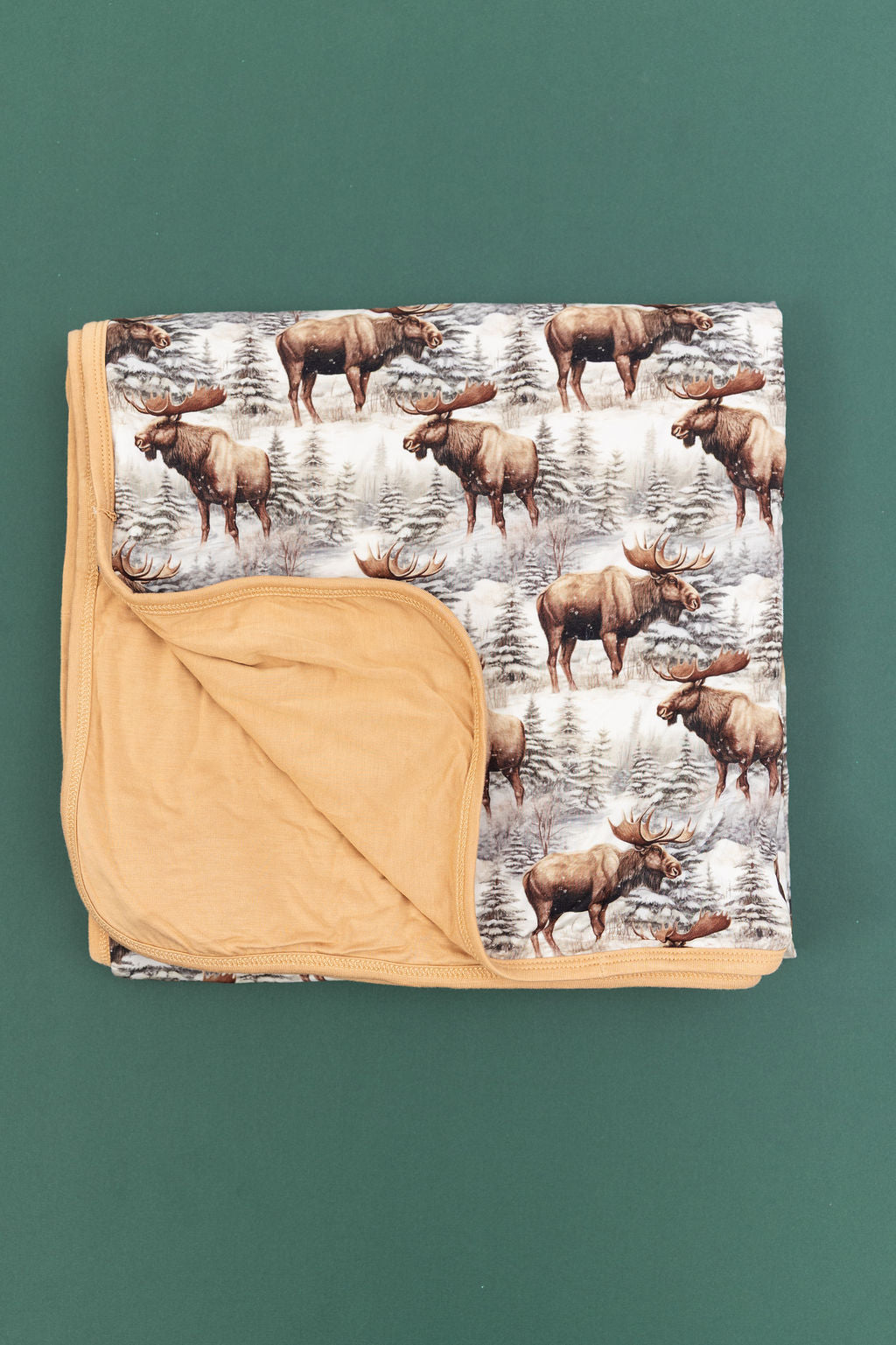 Timberline forest-print bamboo blanket with pine trees and winter-inspired artwork